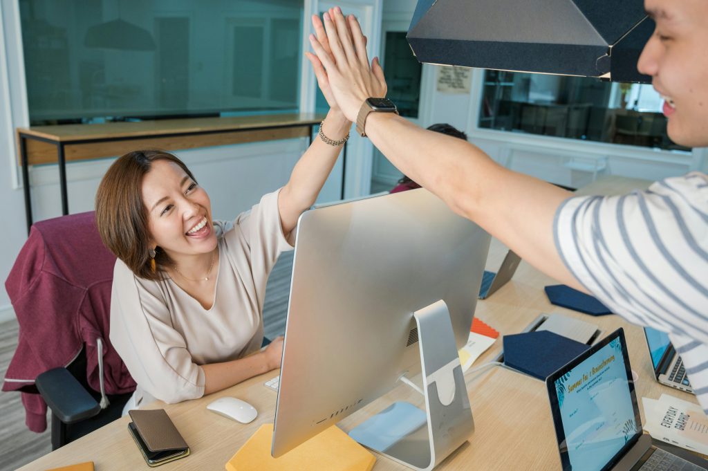 a female student high fiving her friend